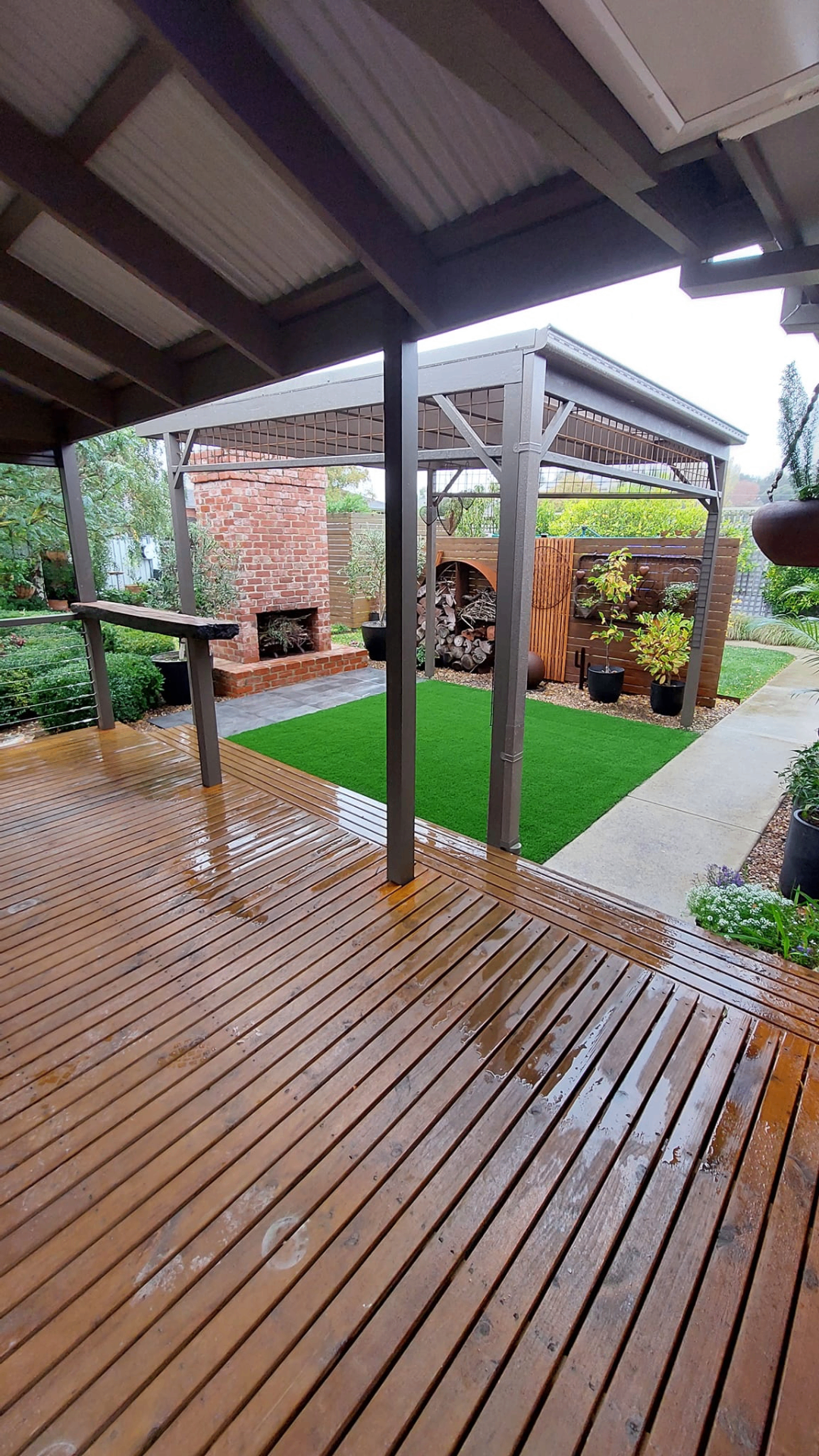 Ballarat landscaping – covered deck with fireplace and turf